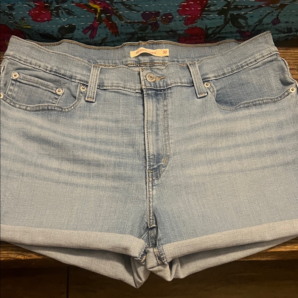 Levi Light Blue Denim Shorts. Ladies size 32 distressed in color  .